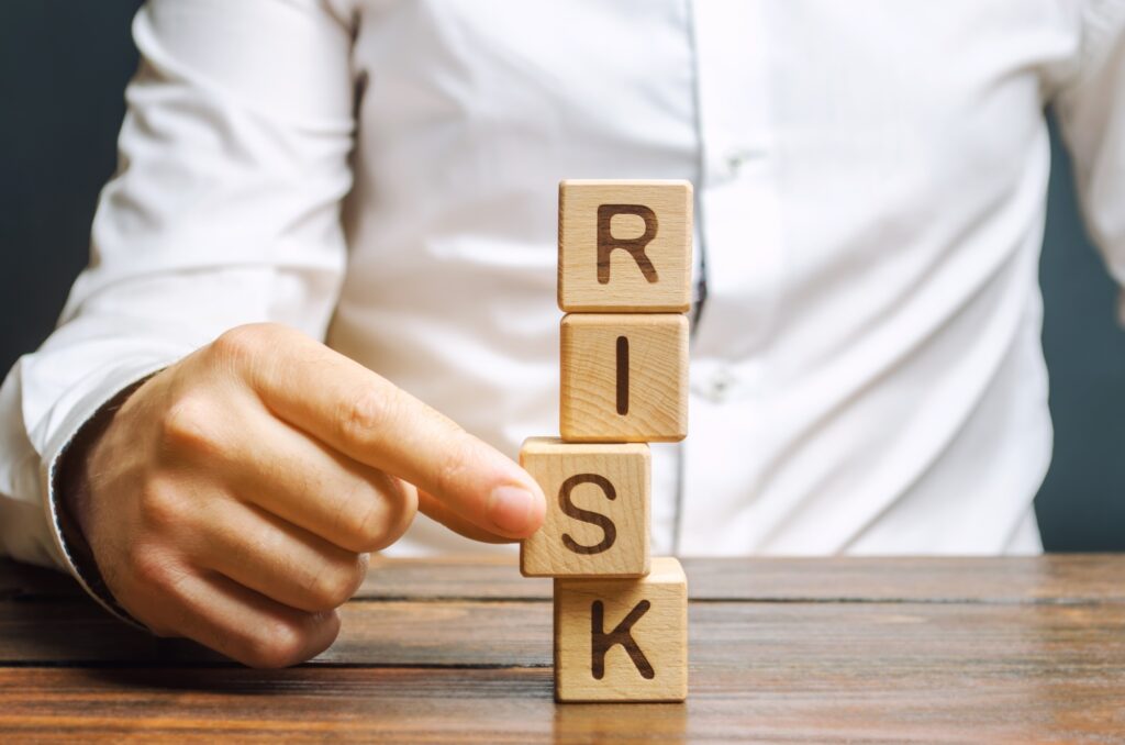 Man removes blocks with the word Risk